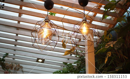 Vintage light bulb decorate on the ceiling in the cafe. Decorative lights for interiors. Vintage light bulb decorate on the ceiling in the cafe. Decorative lights for interiors. 138311153