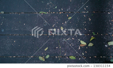 Wooden floor with dry leafs in the garden. Wooden floor with dry leafs in the garden. 138311154