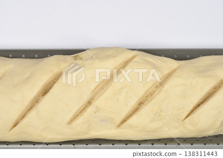 Close up of raw baguette dough on a baking tray Close up of raw baguette dough on a baking tray 138311443