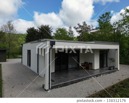 Modular modern minimalist house with covered terrace in a wooded energy efficient setting 138312176