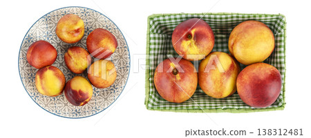 Fresh ripe nectarines arranged on decorative plate and in green basket Fresh ripe nectarines arranged on decorative plate and in green basket 138312481