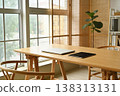 Modern home office setup with laptop and tablet on a wooden desk by the window 138313131
