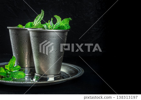 Mint Julep in the Kentucky Derby classic silver glass, with fresh mint leaves 138313197