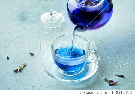 Blue tea, an infusion of butterfly pea flowers, being poured into a cup Blue tea, an infusion of butterfly pea flowers, being poured into a cup 138313198