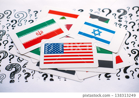 Cards showing United States, Israel, Iran, and Lebanon flags lie on paper covered in question marks. Middle East geopolitical tensions, regional conflict complexity, unstable political landscape. 138313249