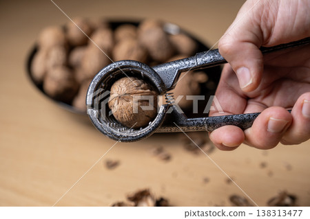 Cracking Walnuts with a Walnut Cracker Cracking Walnuts with a Walnut Cracker 138313477