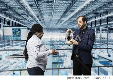 Man in semiconductor factory putting on VR goggles equipment to monitor autonomous electronics. Management executives use virtual reality simulation in industrial plant to enhance productivity Man in semiconductor factory putting on VR goggles equipment to monitor autonomous electronics. Management executives use virtual reality simulation in industrial plant to enhance productivity 138313607