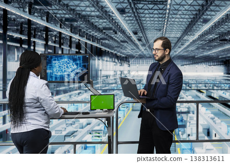 Green screen tablet and AI used by microchip factory managers to manage resource allocation. Directors analyze semiconductor plant operations efficiency using artificial intelligence and mockup device Green screen tablet and AI used by microchip factory managers to manage resource allocation. Directors analyze semiconductor plant operations efficiency using artificial intelligence and mockup device 138313611