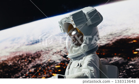 Smiling orbital station crew member delighted by beauty of planet in space. Joyous African american woman looking in awe at galaxy celestial bodies during planetary exploration, camera B 138313648