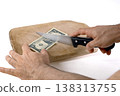 Preparing to Cut Dollar Bills on a Cutting Board 138313755