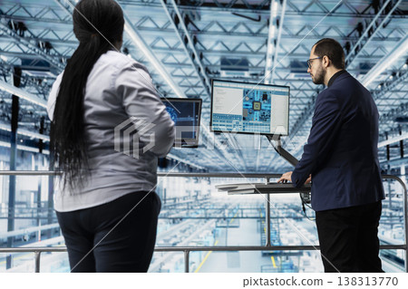 Managers maximizing semiconductors factory production output using software. Management executives analyzing data to troubleshoot and fix industry 4.0 manufacturing plant infrastructure defects Managers maximizing semiconductors factory production output using software. Management executives analyzing data to troubleshoot and fix industry 4.0 manufacturing plant infrastructure defects 138313770