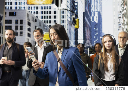 Asian modern professional walking street downtown surrounded by pedestrians crowd, illustrating the timing and flow of movement in busy cityscape. Everyday routine street life. Asian modern professional walking street downtown surrounded by pedestrians crowd, illustrating the timing and flow of movement in busy cityscape. Everyday routine street life. 138313776