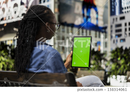 Green screen device used by freelance artist outside using tactile touchscreen to draw, finishing project for client. Woman doing digital art on mockup drawing tablet on city bench Green screen device used by freelance artist outside using tactile touchscreen to draw, finishing project for client. Woman doing digital art on mockup drawing tablet on city bench 138314061