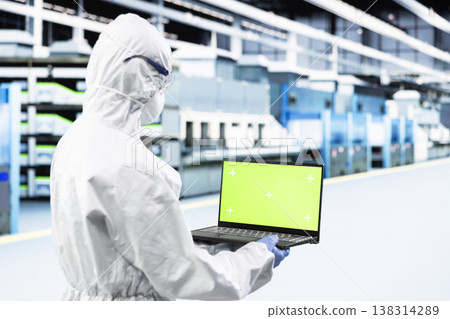 Green screen laptop used by researcher designing silicon wafers in automated manufacturing plant. Tech expert inspecting semiconductor substrates hardware with mockup notebook, doing quality control Green screen laptop used by researcher designing silicon wafers in automated manufacturing plant. Tech expert inspecting semiconductor substrates hardware with mockup notebook, doing quality control 138314289