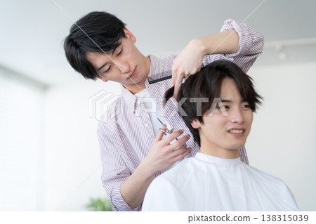 一位年輕男子在理髮店理髮。 138315039