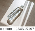 Glass bottle of water, minimalist, lying down. 138315107