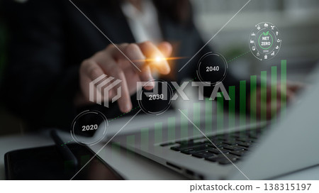 Business Professional Analyzing Financial Growth Trends and Projecting Future Goals with Digital Graphs Representing Net Zero Targets and Milestones Gantry Business Professional Analyzing Financial Growth Trends and Projecting Future Goals with Digital Graphs Representing Net Zero Targets and Milestones Gantry 138315197