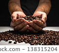 Coffee beans in the palm of a hand (close-up) 138315204