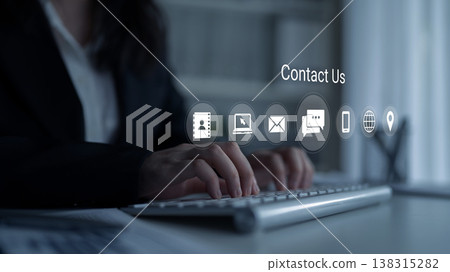 Professional businesswoman typing on keyboard with digital icons representing communication and contact options in modern office setting Gantry Professional businesswoman typing on keyboard with digital icons representing communication and contact options in modern office setting Gantry 138315282
