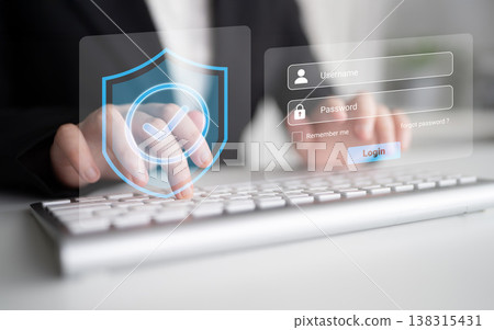 Business professional typing on a keyboard with a digital login screen and security shield icon, emphasizing online safety and data protection concepts Gantry Business professional typing on a keyboard with a digital login screen and security shield icon, emphasizing online safety and data protection concepts Gantry 138315431