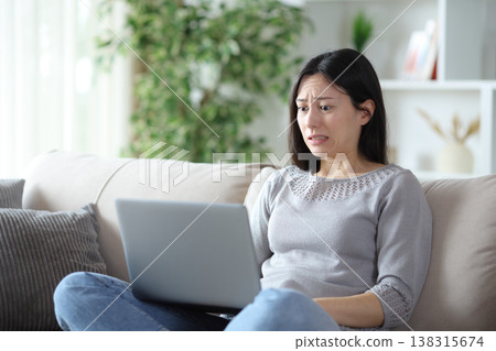Worried asian woman because she messed up online 138315674