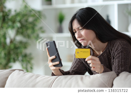 Sad asian woman having problem paying online 138315722