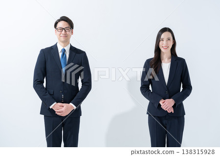 A businessman and his wife facing forward. A businessman and his wife facing forward. 138315928