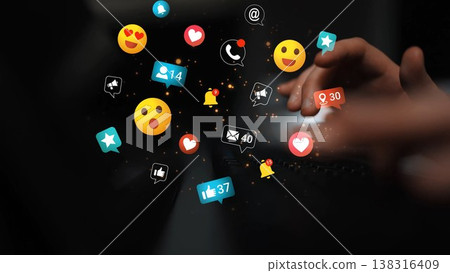 Colorful digital icons and emojis representing social media engagement floating above hands typing on a laptop keyboard in a modern workspace environment Gluon Colorful digital icons and emojis representing social media engagement floating above hands typing on a laptop keyboard in a modern workspace environment Gluon 138316409