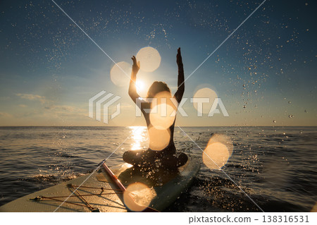 Young woman walking on sup board by the sea during summer vacation 138316531