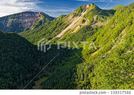 Mount Tengu and Mount Iou in the morning, as seen from near Mount Nyū in the northern Yatsugatake Mountains. 138317588