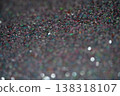 Close-up of colorful glitter particles creating a shimmering background texture for design projects 138318107