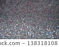 Close-up of shimmering glitter surface with colorful reflections and sparkling texture 138318108