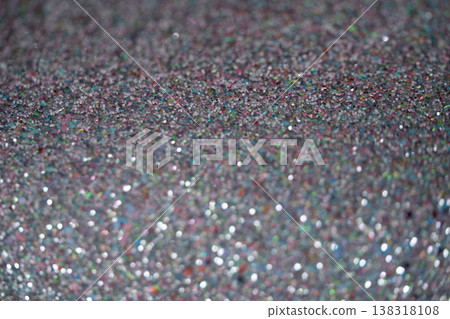 Close-up of shimmering glitter surface with colorful reflections and sparkling texture Close-up of shimmering glitter surface with colorful reflections and sparkling texture 138318108