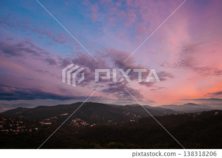 Soft pastel sunset sky over rolling mountain hills near Barcelona Soft pastel sunset sky over rolling mountain hills near Barcelona 138318206