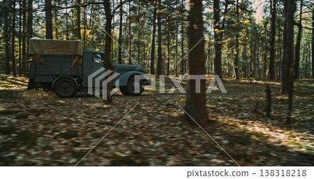 Vintage German truck driving through forest with motion blur during WWII Vintage German truck driving through forest with motion blur during WWII 138318218