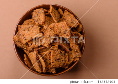 Croutons or crackers made from rye bread with garlic, salt, and spices. Croutons with salt Croutons or crackers made from rye bread with garlic, salt, and spices. Croutons with salt 138318503