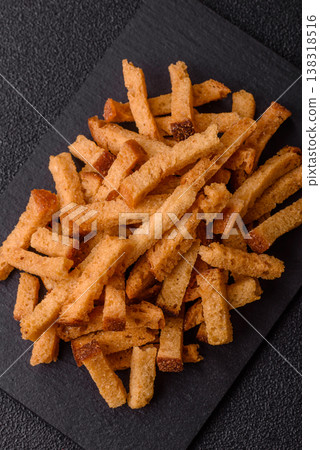 Croutons or crackers made from rye bread with garlic, salt, and spices. Croutons with salt Croutons or crackers made from rye bread with garlic, salt, and spices. Croutons with salt 138318516