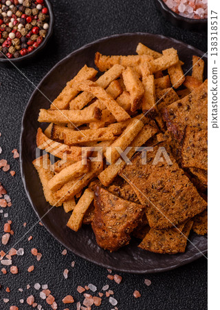 Croutons or crackers made from rye bread with garlic, salt, and spices. Croutons with salt Croutons or crackers made from rye bread with garlic, salt, and spices. Croutons with salt 138318517