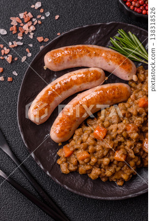 Lentil, carrot, and tomato stew with sausages, a European dish. Lentils with sausages 138318526