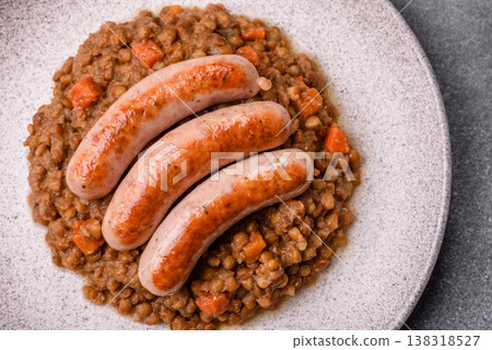 Lentil, carrot, and tomato stew with sausages, a European dish. Lentils with sausages 138318527