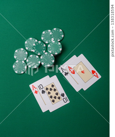 Playing cards and chips on a green cloth, a gambling game of blackjack or baccarat. Cards and chips 138318594