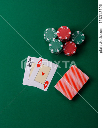 Playing cards and chips on a green cloth, a gambling game of blackjack or baccarat. Cards and chips Playing cards and chips on a green cloth, a gambling game of blackjack or baccarat. Cards and chips 138318596