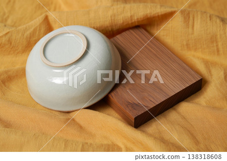empty ceramic cup on the cutting board 138318608
