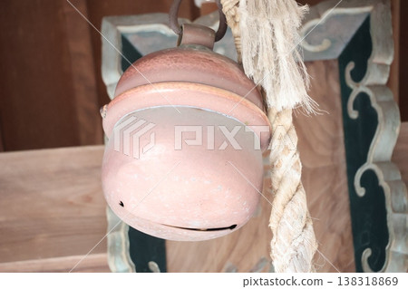A scene with a large bell and rope at a shrine. A scene with a large bell and rope at a shrine. 138318869