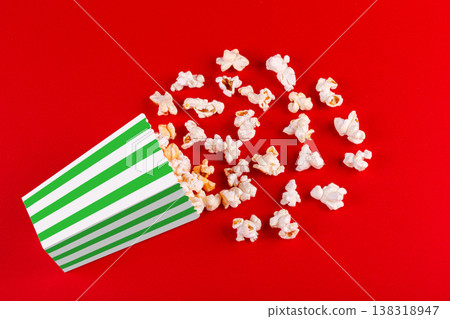 box with popcorn striped in different colors on a red background box with popcorn striped in different colors on a red background 138318947