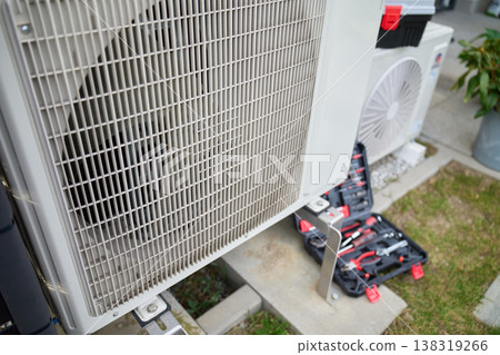 Outdoor heat pump unit with tools during maintenance Outdoor heat pump unit with tools during maintenance 138319266