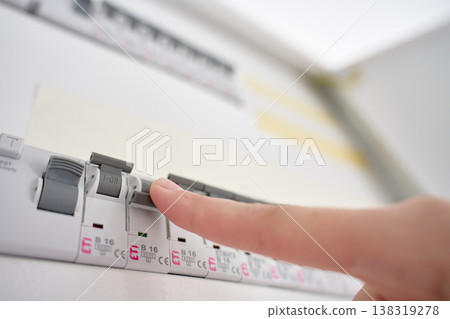 Hand switching circuit breaker in electrical distribution panel 138319278