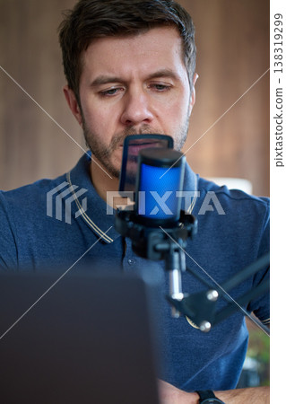 Close up of man speaking in podcast microphone at home Close up of man speaking in podcast microphone at home 138319299