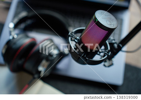 Podcast microphone with laptop and headphones on desk Podcast microphone with laptop and headphones on desk 138319300