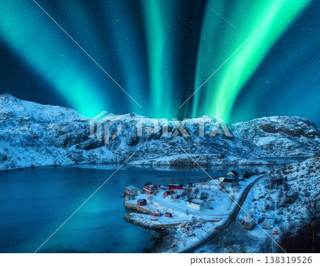 Polar lights over the snowy mountains, sea at night in Lofoten Polar lights over the snowy mountains, sea at night in Lofoten 138319526